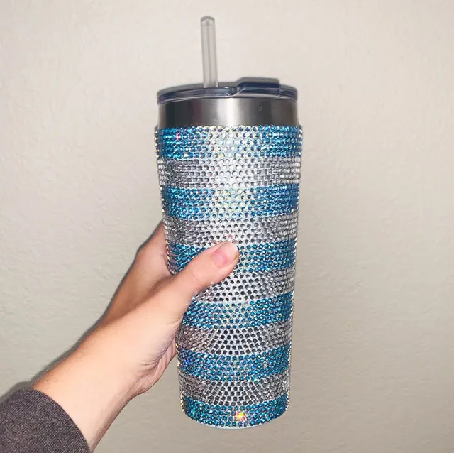 Tumbler covered in silver and blue rhinestone stripes