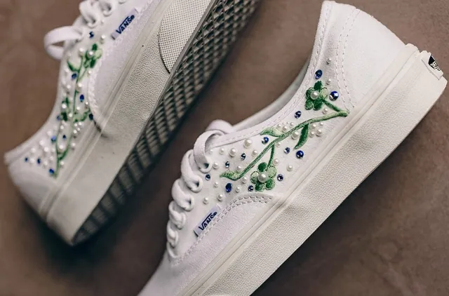 Close-up of sneakers with green vines and crystals