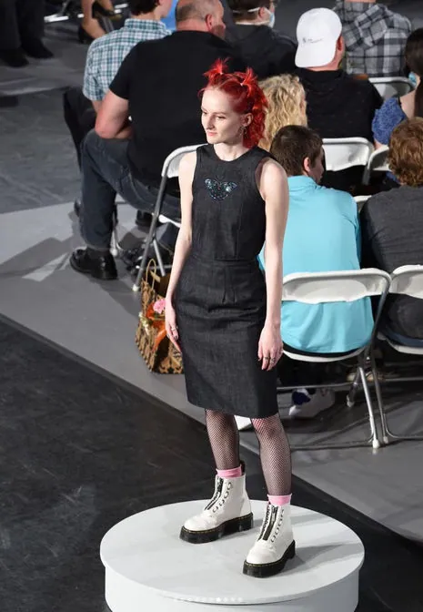 Model in a black dress on the runway