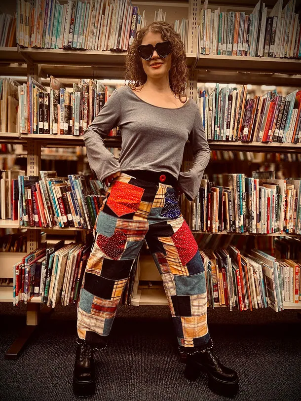 Patchwork pants with a grey top in the library