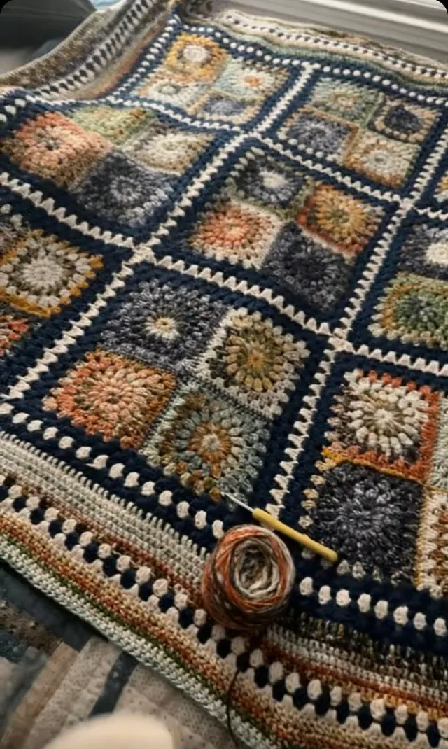 Dark granny-square blanket with a ball of yarn